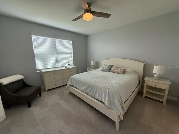 a bedroom with a bed and a large mirror