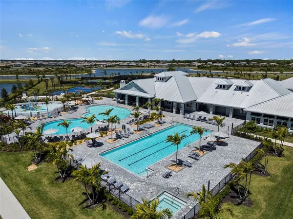 an aerial view of a with swimming pool outdoor seating and yard