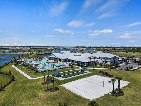 an aerial view of a house with a swimming pool outdoor seating and yard