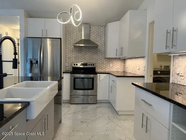 a kitchen with granite countertop a sink stainless steel appliances and cabinets