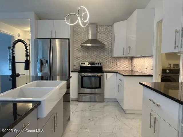 a kitchen with granite countertop a stove a sink and a refrigerator