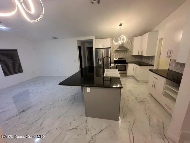 a living room with couches a flat tv screen and a fireplace