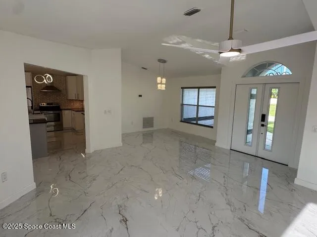 a view of a hallway with wooden cabinet and a living room