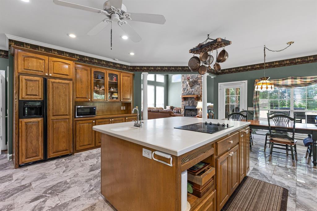 7581 Highway 24 Commerce, TX 75428 - Photo 13 of 40 a kitchen with stainless steel appliances granite countertop a sink a stove and a refrigerator