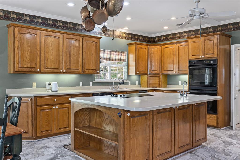 7581 Highway 24 Commerce, TX 75428 - Photo 15 of 40 a kitchen with stainless steel appliances granite countertop a sink a stove and a refrigerator
