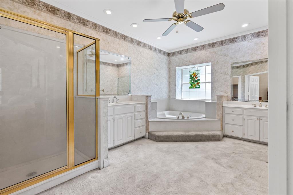 7581 Highway 24 Commerce, TX 75428 - Photo 19 of 40 a bathroom with a tub sink shower and mirror