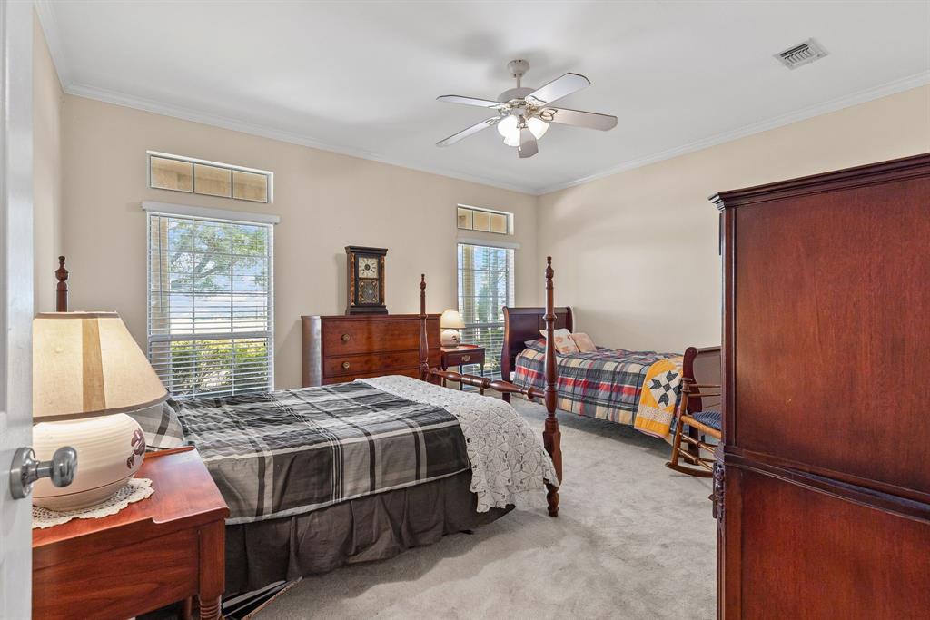 7581 Highway 24 Commerce, TX 75428 - Photo 23 of 40 a bedroom with a bed and a chandelier