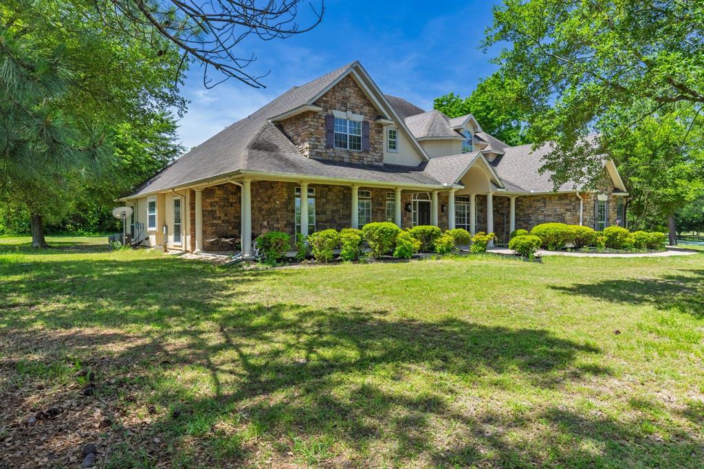 7581 Highway 24 Commerce, TX 75428 - Photo 3 of 40 a front view of a house with a garden