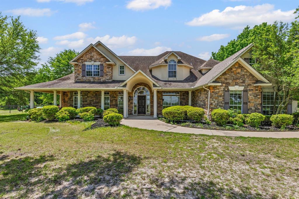 7581 Highway 24 Commerce, TX 75428 - Photo 4 of 40 a front view of a house with a yard