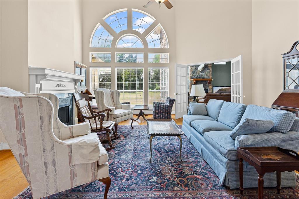 7581 Highway 24 Commerce, TX 75428 - Photo 9 of 40 a living room with furniture a fireplace and a large window