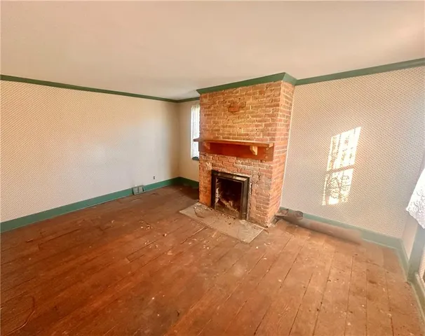 a view of empty room with fireplace and fan