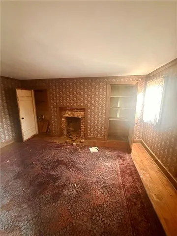 a view of a hallway with brick walls