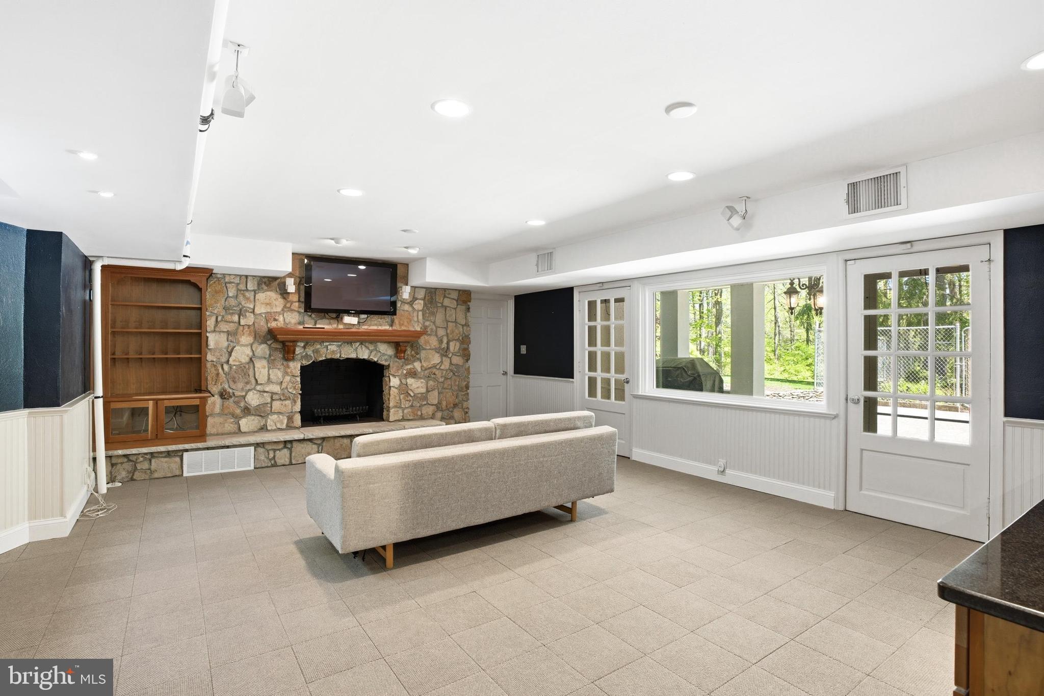 4511 Province Line Road Princeton, NJ 08540 - Photo 20 of 34 a living room with furniture a flat screen tv and a fireplace