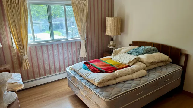 a bedroom with furniture and a window