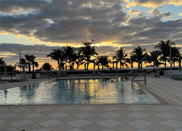 a room with furniture a flat screen tv and a fireplace