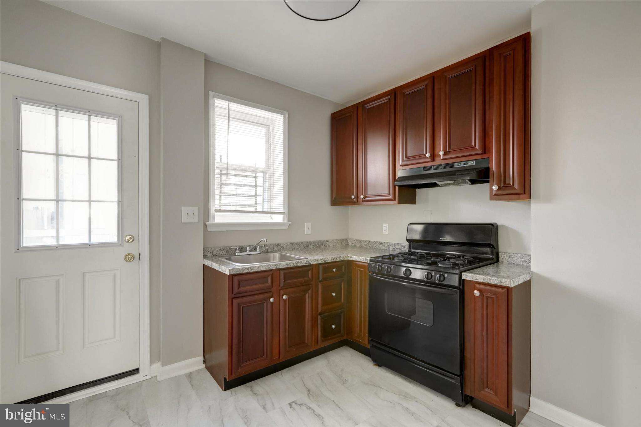 1210 Whitelock Street Baltimore, MD 21217 - Photo 15 of 51 Charming kitchen with rich wood cabinetry.