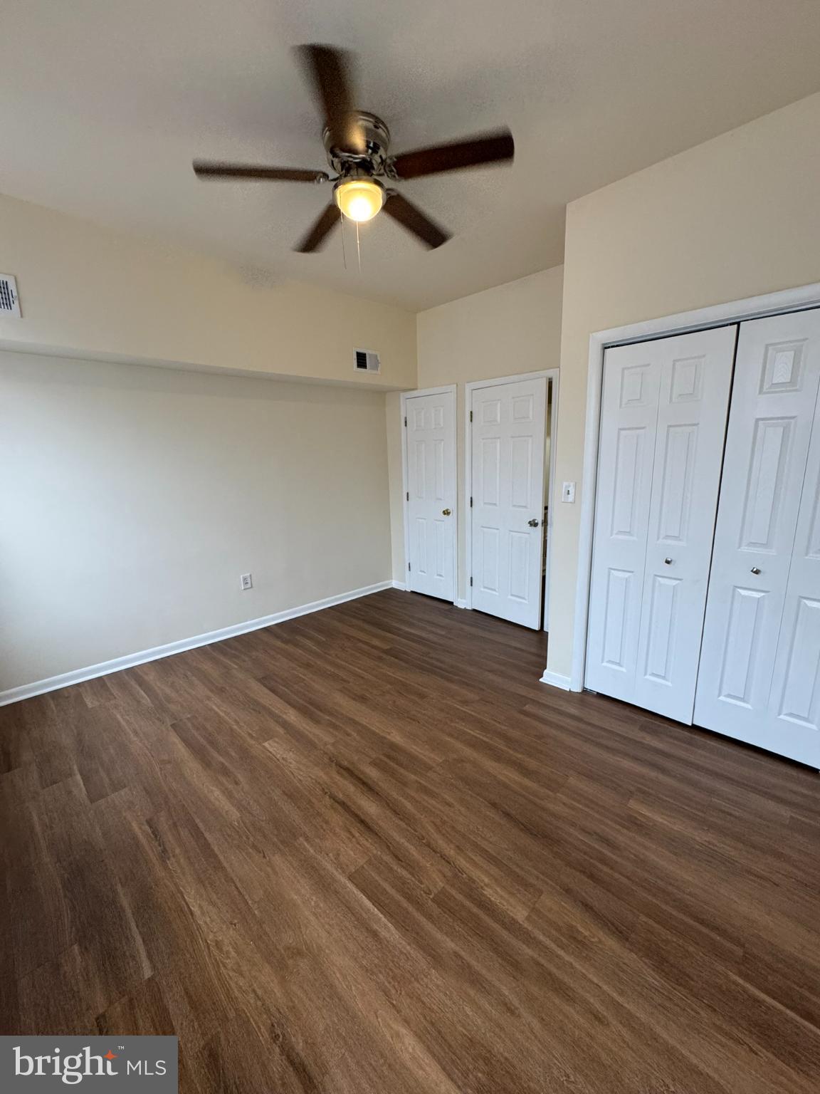 1210 Whitelock Street Baltimore, MD 21217 - Photo 19 of 33 an empty room with wooden floor and fan