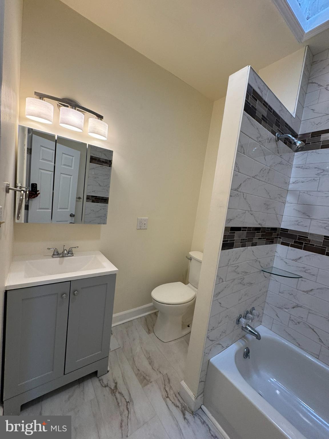 1210 Whitelock Street Baltimore, MD 21217 - Photo 23 of 33 a bathroom with a sink a toilet and shower