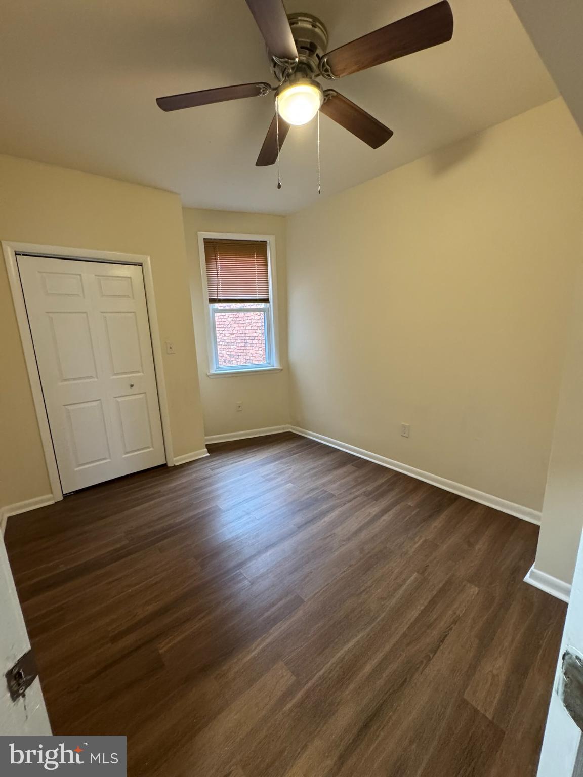 1210 Whitelock Street Baltimore, MD 21217 - Photo 25 of 33 a view of an empty room with wooden floor and a ceiling fan