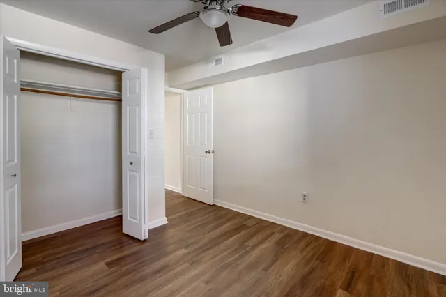 a view of an empty room with wooden floor