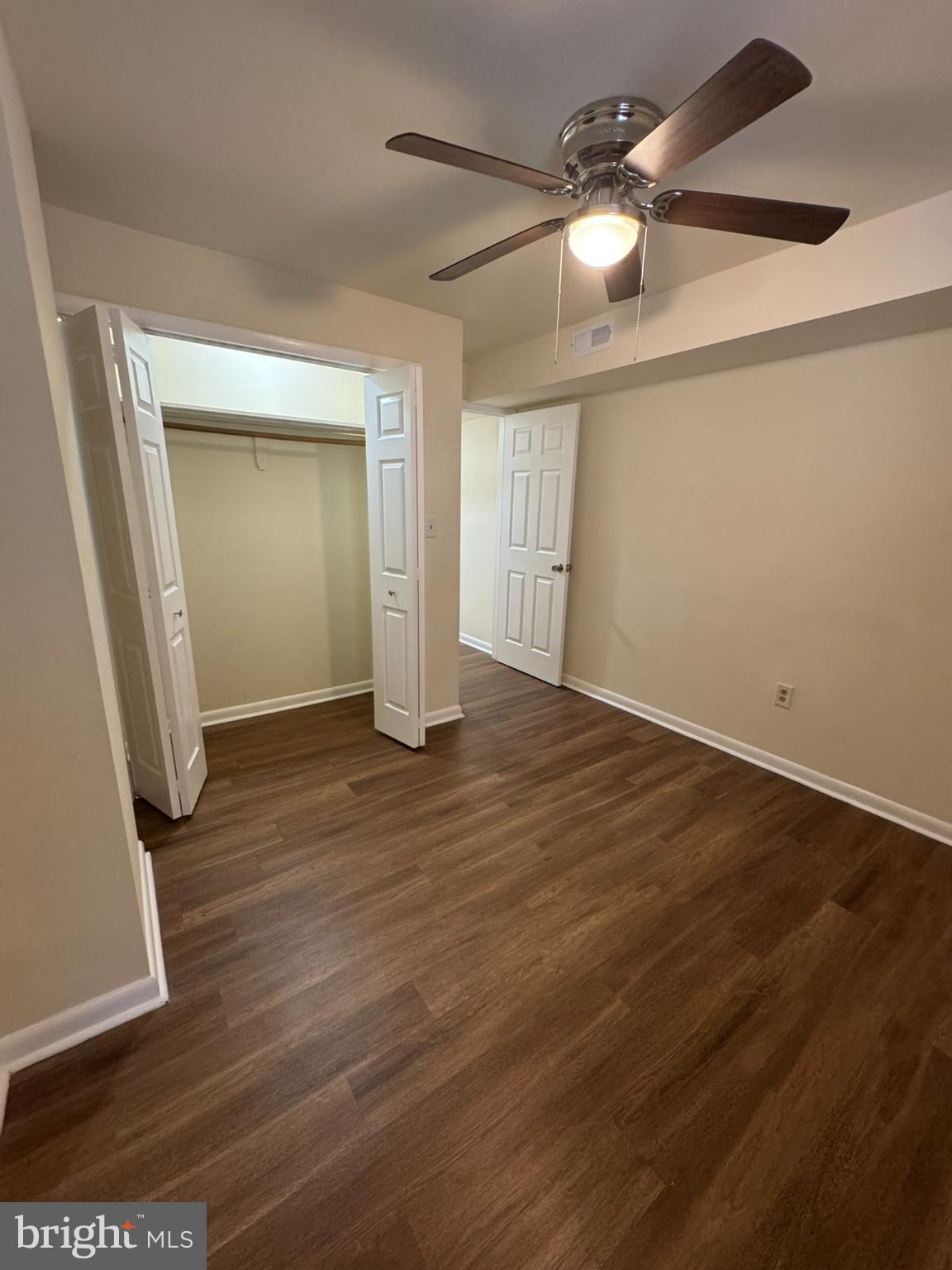 1210 Whitelock Street Baltimore, MD 21217 - Photo 30 of 33 an empty room with wooden floor and fan
