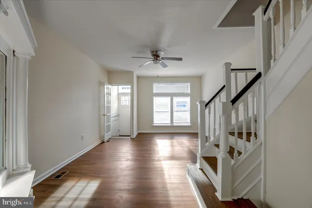 a view of an entryway with wooden floor and stairs