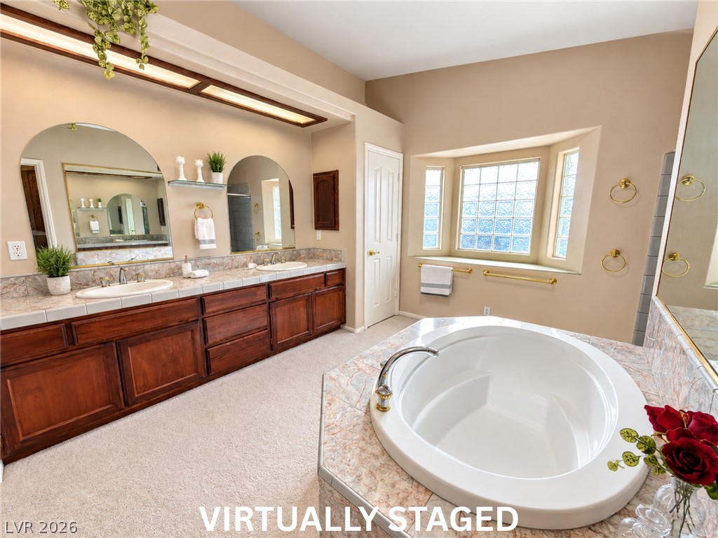 5470 Grain Mill Road Pahrump, NV 89061 - Photo 29 of 80 VIRTUALLY STAGED An expansive vanity and deep soaking tub define this relaxing primary bath layout.