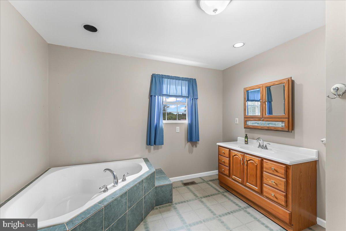 139 High Point Road Cochranville, PA 19330 - Photo 25 of 37 a bathroom with a tub sink and mirror