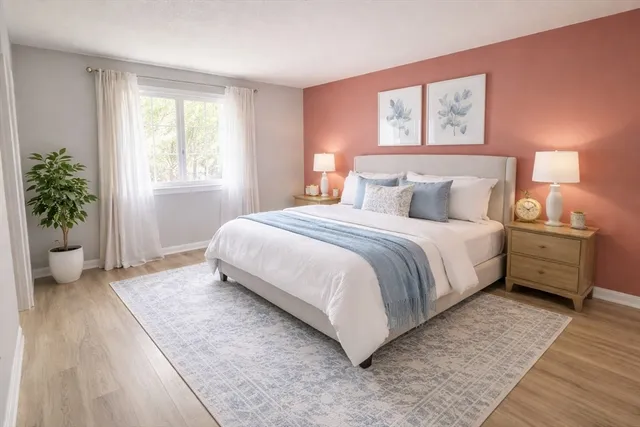 a bedroom with a bed and a potted plant