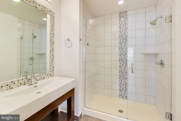 a bathroom with a bathtub shower sink and a shower