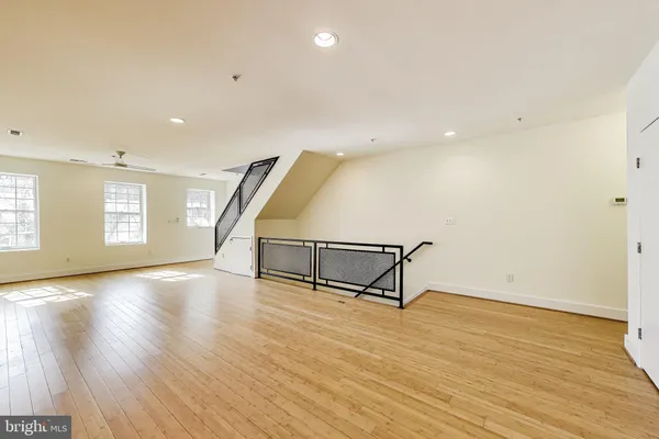 a view of a room with wooden floor and windows