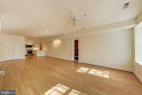 a view of empty room with wooden floor