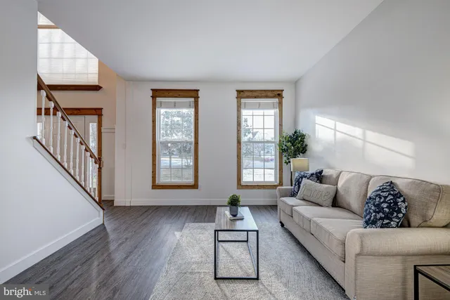 a kitchen with stainless steel appliances granite countertop a refrigerator a sink dishwasher and wooden cabinets with wooden floor