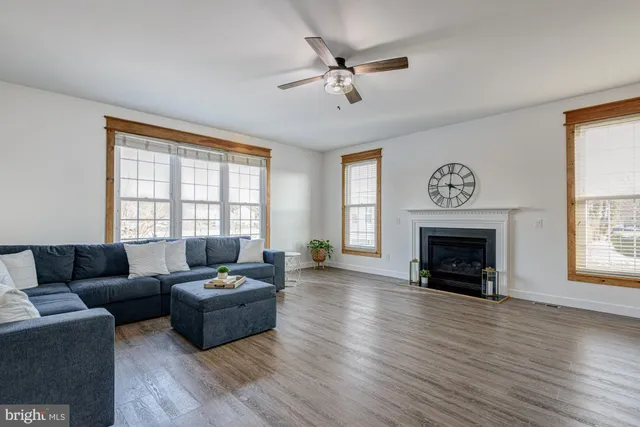 a spacious bedroom with a bed a chandelier and window