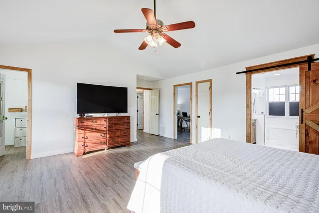 a bedroom with a bed and flat screen tv