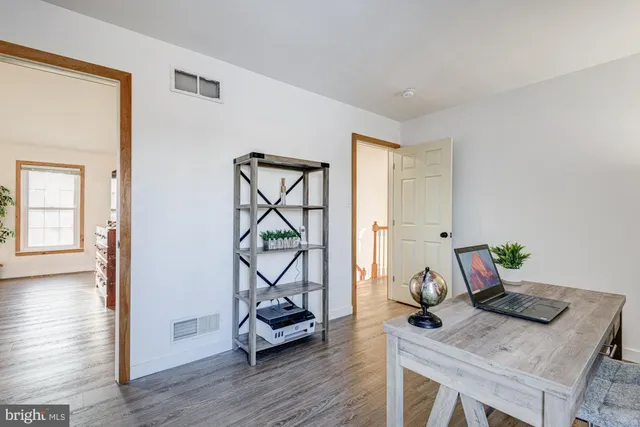 a bathroom with a sink vanity mirror and toilet