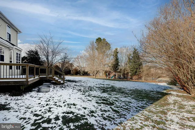 a view of a roof deck with wooden fence and floor