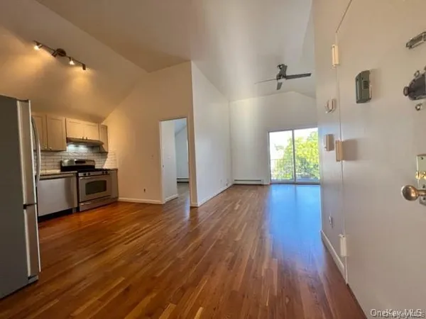 a kitchen with stainless steel appliances granite countertop a stove a refrigerator and a microwave