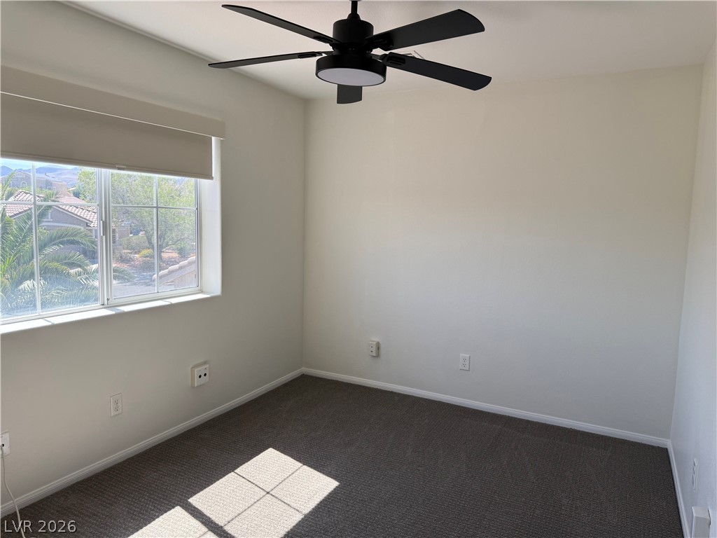 1141 Cathedral Ridge Street Henderson, NV 89052 - Photo 39 of 77 This bright room features a window with views and a ceiling fan for comfort.