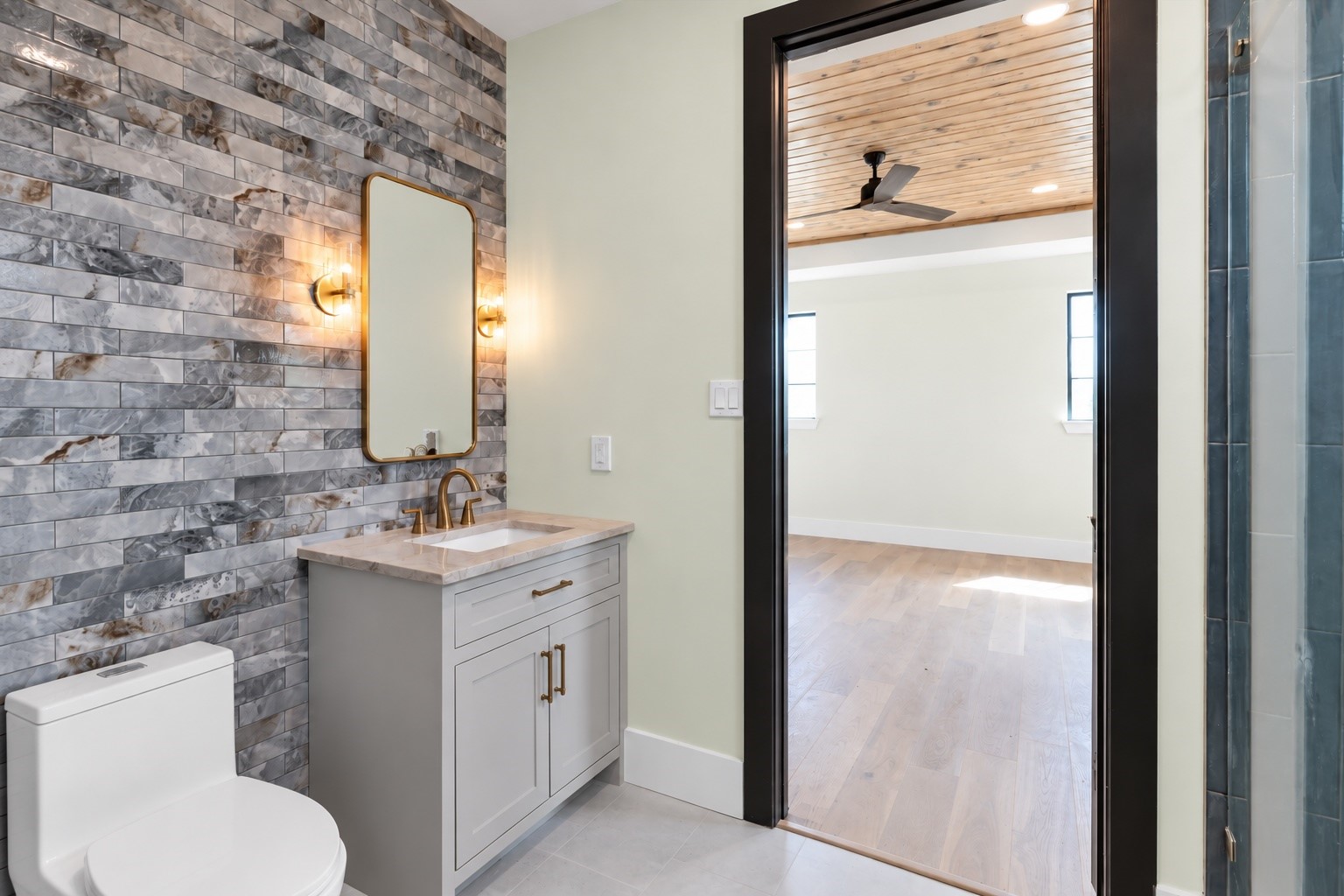 23701 Birch Grove Road Montgomery, TX 77316 - Photo 36 of 50 The fourth bedroom boasts a stylish private bathroom featuring a sleek vanity and elegant tiled walls, offering a perfect blend of comfort and modern aesthetics.
