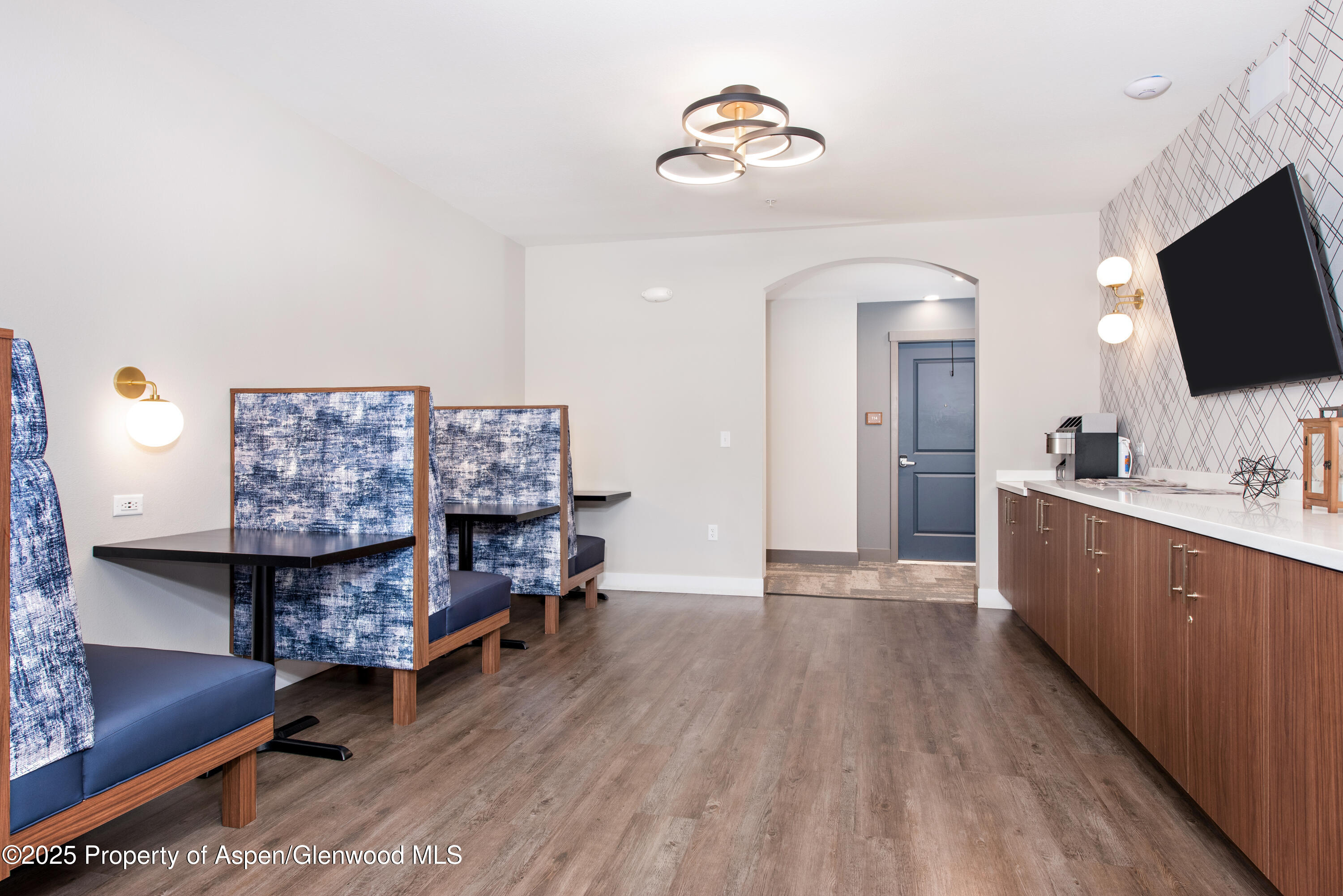 253 Wulfsohn Road, Unit 324 Glenwood Springs, CO 81601 - Photo 15 of 45 a living room with furniture and a flat screen tv