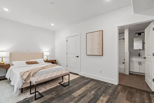 a bedroom with a bed and a table