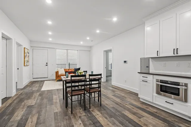 a view of a kitchen with dining table and chairs