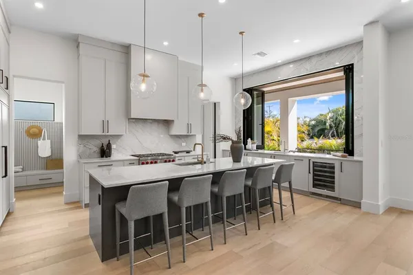 a kitchen with stainless steel appliances a sink a stove and a wooden floors
