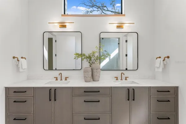 a bathroom with a granite countertop sink mirror and vanity