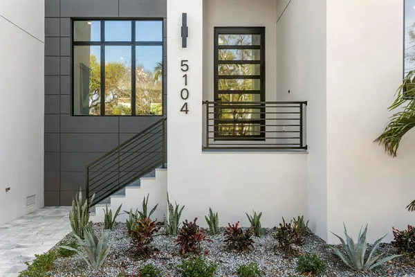 a large kitchen with a table and chairs