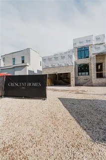a black white building with a large tree in front of it