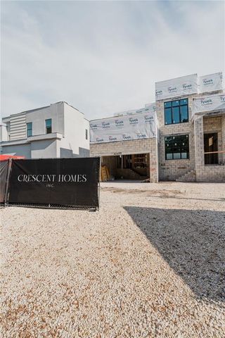 a black white building with a large tree in front of it