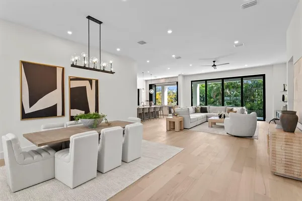 a open kitchen with stainless steel appliances kitchen island granite countertop a sink a stove and a living room view