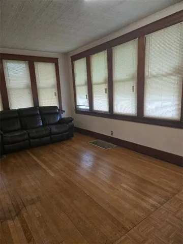 a living room with furniture and large windows